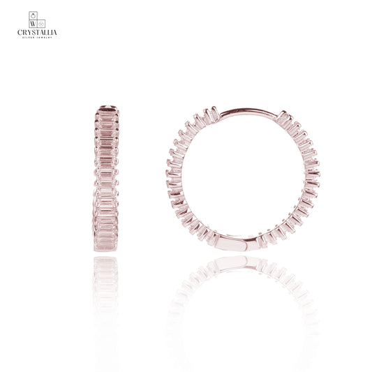 זוג עגילי כסף 925 נופלים בגוון רוז גולד יוקרתי, מעוטרים באבני זרקון מנצנצות למראה אלגנטי ומרשים של מותג התכשיטים קריסטליה.